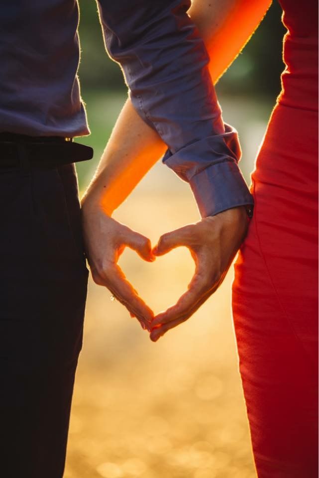 Couple making heart shape with hands representing shared values