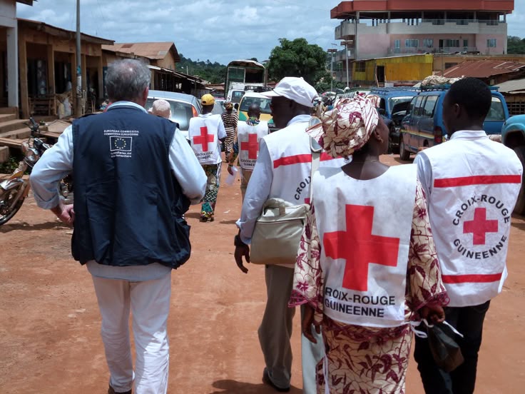 A healthcare worker distributing clean water and hygiene supplies to residents in Abidjan during the 2025 cholera outbreak