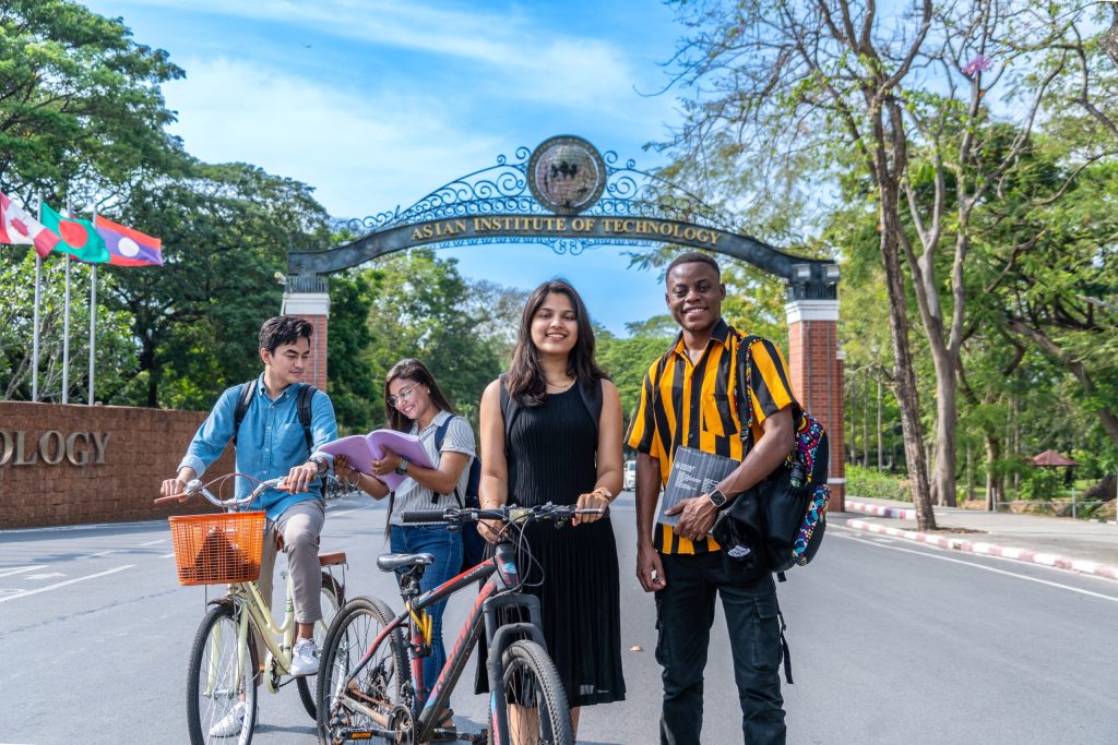 AIT campus arch with students awaiting graduation under scholarship program
