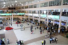 Passengers boarding an international flight at Lagos airport showing ticketing counters