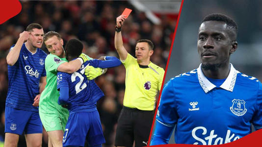 Idrissa Gueye being shown a red card by referee Tony Harrington after incident with Michael Keane