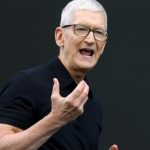Tim Cook delivering a presentation on stage at Apple Park during a keynote address.