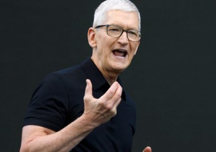 Tim Cook delivering a presentation on stage at Apple Park during a keynote address.
