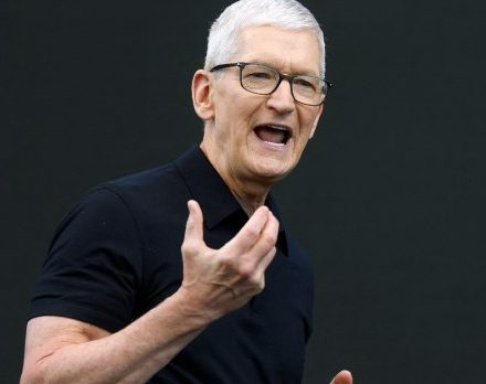 Tim Cook delivering a presentation on stage at Apple Park during a keynote address.