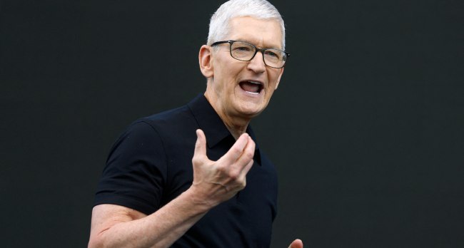 Tim Cook delivering a presentation on stage at Apple Park during a keynote address.