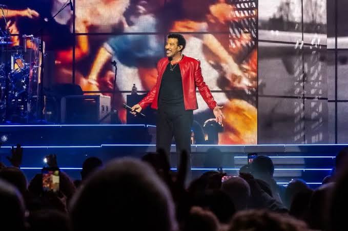 Lionel Richie performing live on stage during his 2026 concert tour.