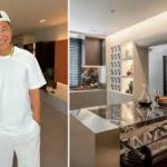 Terence Cao sitting inside his newly renovated industrial-style dining area next to a black granite island.