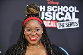 Carla Jeffery smiling at a red carpet event.