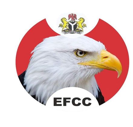 EFCC Chairman Ola Olukoyede speaking at a press conference alongside digital cryptocurrency icons.
